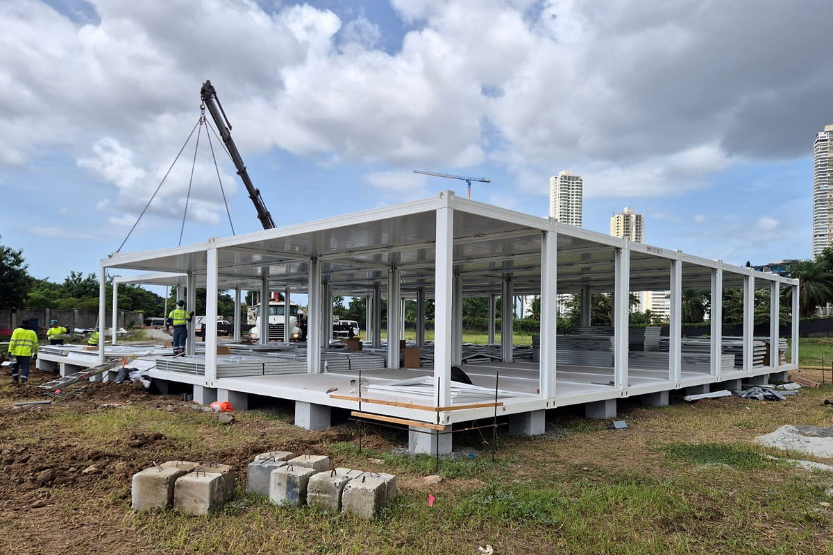 Light-gauge steel frame erected on site from a NewCon Steel structural kit, with the Panama City skyline behind